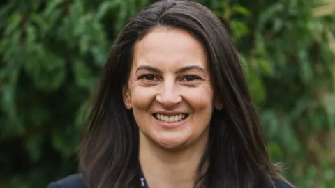Twycross Zoo Dr Rebecca Biddle, who has long dark hair, smiling at the camera.