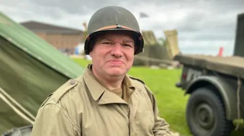 Emma Baugh/BBC Mark Bailey dressed in an Allied World War Two uniform at Duxford