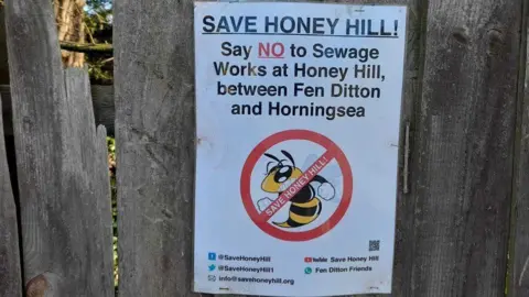 LDRS Sign on wooden fence opposing sewage works plans and saying Save Honey Hill