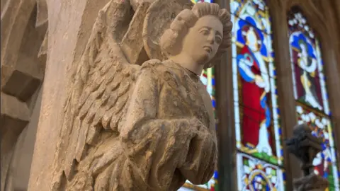 Stone carved angel on a pillar in the cathedral.