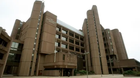 PA Media Liverpool Crown Court, which is a six storey building with brown concrete cladding and cylindrical structures at its corners