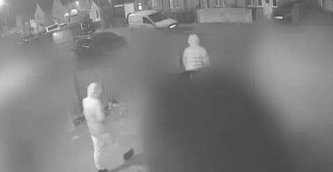 Avon and Somerset Police CCTV image of Max and Mason leaving a house, with both wearing hooded coats. 