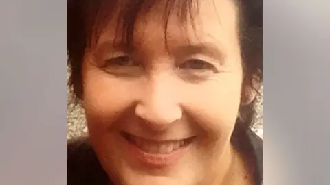 PA Paula Leeson smiles in a cropped photo. She has brown hair and a long fringe.