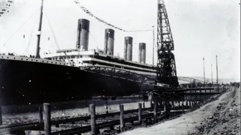 Henry Aldridge and Son via Press Association A black and white photo of the Titanic in the dock in Belfast as it was launched ion 31 May 1911