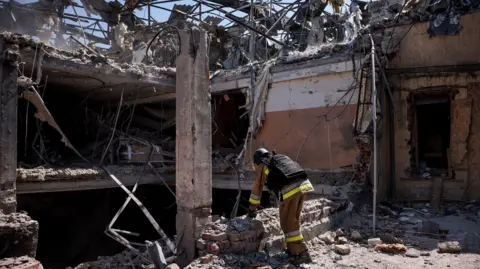 Reuters Ukrainian emergency responders conduct a search and rescue operation amongst the rubble of a destroyed hotel following a Russian strike in the town of Kramatorsk on August 24.