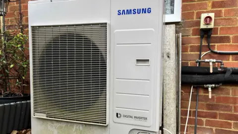 The grey heating unit fitted on the outside of Tina Williams home has had problems ever since it was installed in 2018.