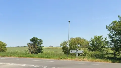 A view of roadsigns for Ramsey and Whittlesey at a junction on the B1095.