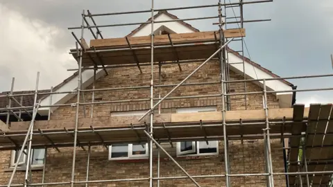 Supplied Scaffolding erected at a two-storey brown brick house.