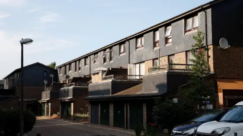 Facundo Arrizabalaga/MyLondon A row of homes on the estate with grey tiles and four balconies. 