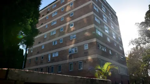Getty Images A tall brick building with lots of windows