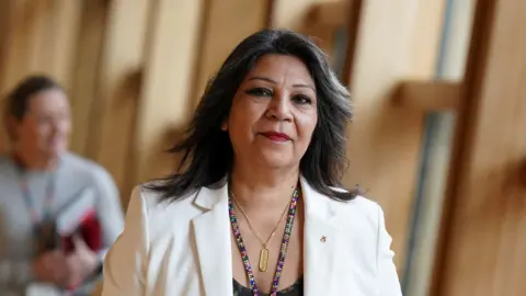 PA Media Kaukab Stewart arriving at Holyrood dressed in white