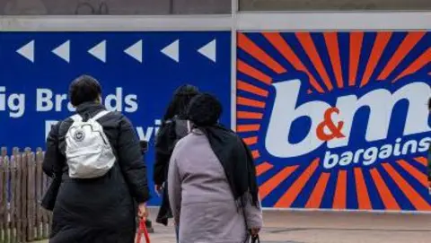 B&M Bargains store at Priory Square shopping centre on 21st March 2024 in Birmingham, United Kingdom. The picture shows the logo and people outside the shop. 