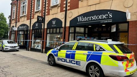 Police car and cordon outside Waterstones in Norwich