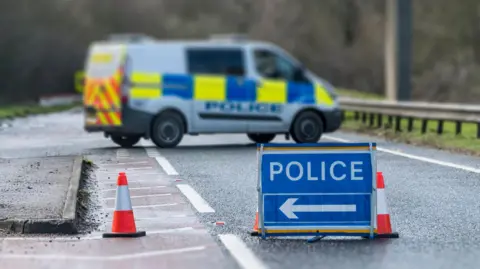 Police Sign on Road with Police Van - stock photo