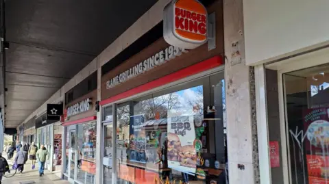 A row of shop fronts with Burger King in the foreground