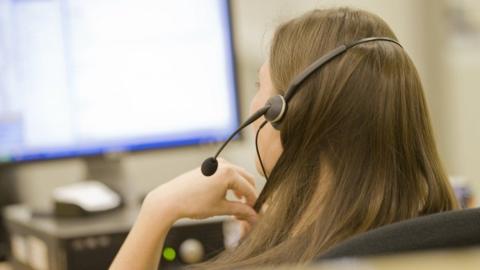 woman wearing headset and working in a call centre