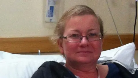 GILL MURPHY Woman in a hospital bed