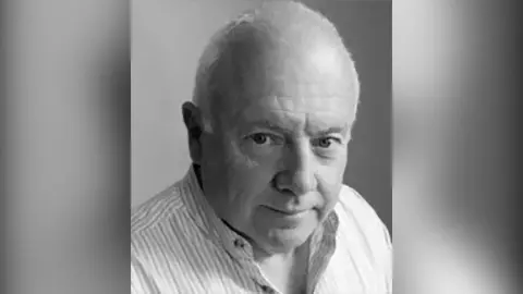 Richard Francis Black and white image of author Richard Francis. He has white hair and is wearing a striped shirt.