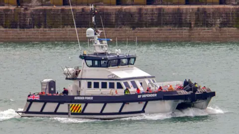 BBC A border force boat with people on it