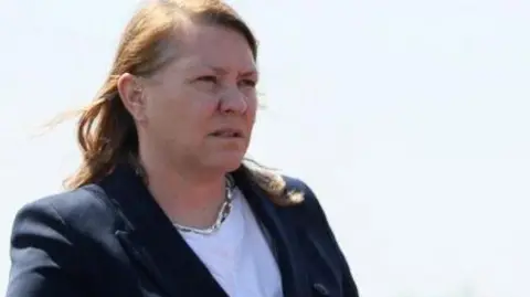 PA Media Anna Turley has long red hair, a white T-shirt and blue jacket