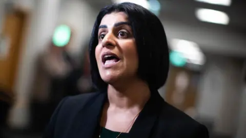 Shabana Mahmood wearing black in a corridor