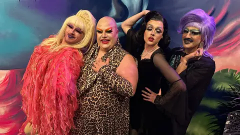 Four drag artists posing for a photo.