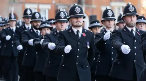 Essex Police A group of Essex Police officers in uniforms marching. They appear to be outside the force's headquarters