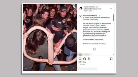 Valentino/Instagram A screenshot of @maisonvalentino's post on Instagram of its AI-generated video advert shows a crowd of people with long, curved arms twisted to resemble the Valentino Garavani logo, besides a text caption.