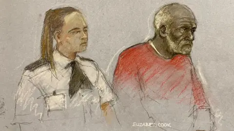 Court drawing of Ryland Headley, who is wearing a red top and has receeding white hair and a beard, sitting next to a female police officer in uniform with her hair tied into a pony tail.
