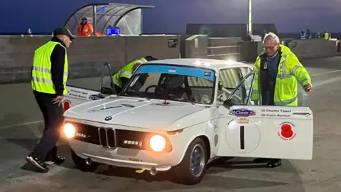 Claire Norman Three men working on a white BMW 2002ti