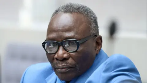ANP/AFP/Getty Images Ali Muhammad Ali Abd-Al-Rahman looks ahead at the hearing, wearing a light blue suit