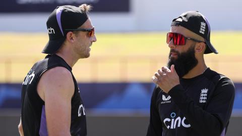 England players Jos Buttler and Moeen Ali talking to each other at a training session