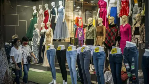 Getty Images Jeans are displayed on mannequins outside a store during the Diwali festival in New Delhi, India, on Wednesday, Nov. 3, 2021. 