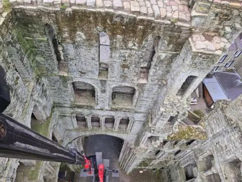 KHS A view down the inside of Kelso Abbey from a cherry-picker - it is surrounded by very mossy brickwork