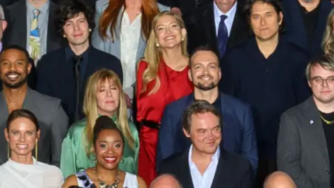 AMPAS Kate Hudson in the Oscars class photo, wearing a red dress