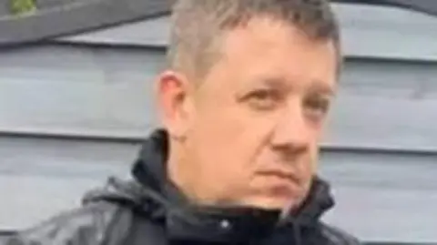 Central Scotland News Agency A man in his 40s with short greying hair looks away from the camera 