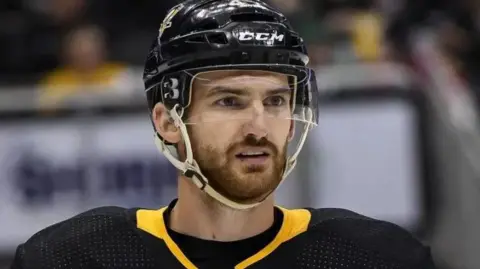 Getty Images Head and shoulders shot of Adam Johnson on the ice during a game with NHL side Pittsburgh Penguins