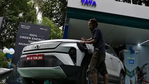 A man cleans a Tata Harrier EV during the launch of the TATA EV charging hub in Mumbai, India, on September 9, 2025.