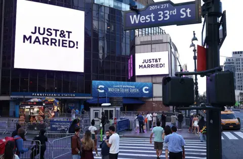 AFP via Getty Images A giant screen shows the message "JUST&T MARRIED!" (T&T for Taylor and Travis) outside Madison Square Garden, the reported venue for the wedding celebrations of pop singer Taylor Swift and pro-athlete Travis Kelce