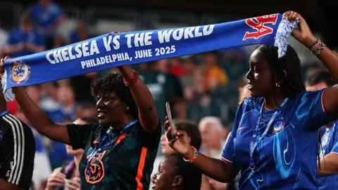 Chelsea fans hold aloft a scarf inside Lincoln Financial Field