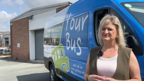 Karen Shore, the deputy leader of Cheshire West and Chester Council, in front of a Your Bus.