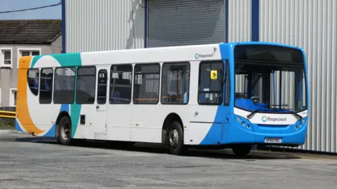 Billy McCrorie A Stagecoach bus at its depot in Stranraer with blue, green and orange swirls on a white vehicle