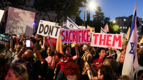 Reuters Israelis attend a protest in Jerusalem demanding that the Israeli government agree a deal to secure the release of the hostages held by Hamas and not endanger them by launching an offensive in Gaza City (3 September 2025)