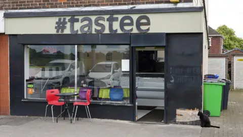 Oli Constable/BBC The outside of a cafe with two large windows