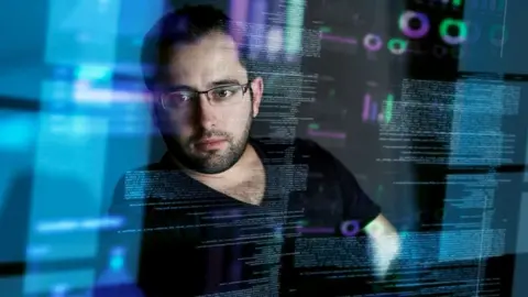 Getty Images Stock photo, posed by a model, of a man looking at computer data  qhiddqidriddxinv