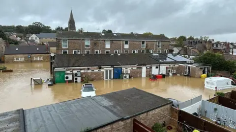 A street in Wheatley that is underwater. The water is a at least a foot and a half high.