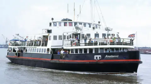 Mersey Ferry on the River Mersey with passengers onboard.