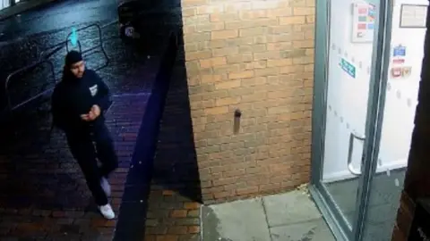 Leicestershire Police An still CCTV image of a man waling into a building