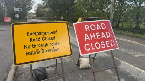 Two roadwork signs, one saying 'Easthampstead Road Closed No through route Follow Diversion' and 'Road ahead closed'