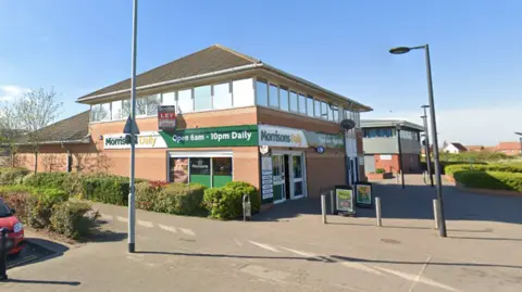 Google The Morrisons Daily on Preston Road in Hull. The sign on the store reads "Morrisons Daily - open 6am to 10pm daily". 